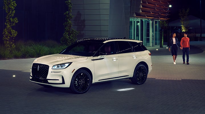 Two people approach a 2024 Lincoln Corsair® SUV featuring the available Jet Appearance Package. | Greenwood Lincoln in Bowling Green KY