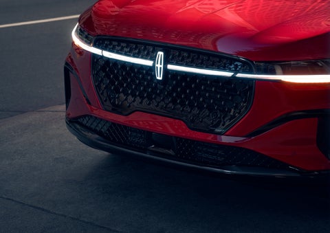 The available front LED light bar and center Lincoln Star logo glow at dusk. | Greenwood Lincoln in Bowling Green KY