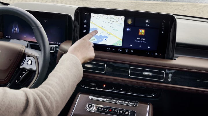 A person is tapping the center display touchscreen of a 2026 Lincoln Aviator® SUV. | Greenwood Lincoln in Bowling Green KY