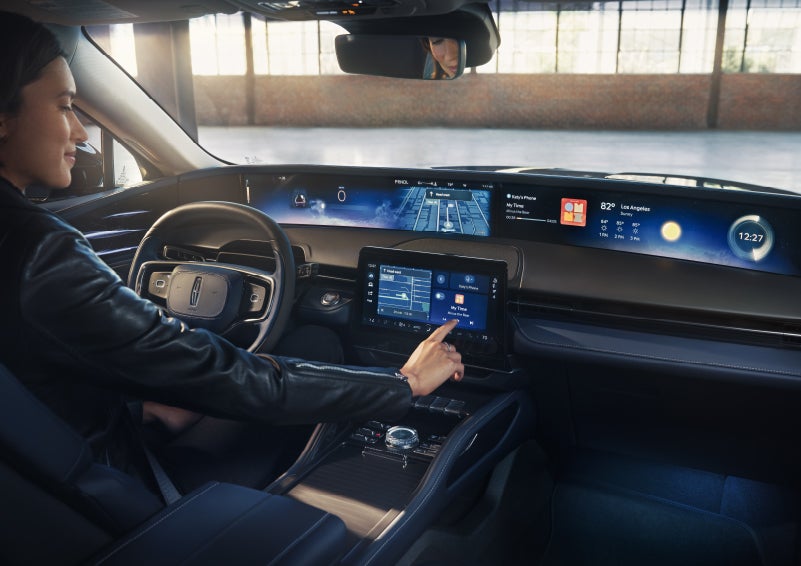 The driver of a 2026 Lincoln Nautilus® SUV interacts with the center touchscreen. | Greenwood Lincoln in Bowling Green KY