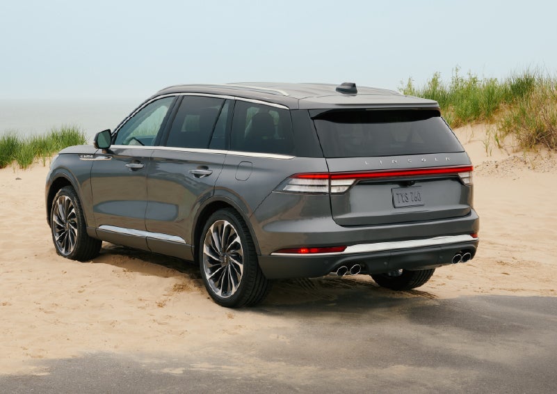 A 2027 Lincoln Aviator® SUV is parked next to sand dunes. | Greenwood Lincoln in Bowling Green KY