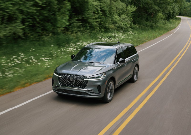 A 2027 Lincoln Aviator® SUV is being driven down a road. | Greenwood Lincoln in Bowling Green KY