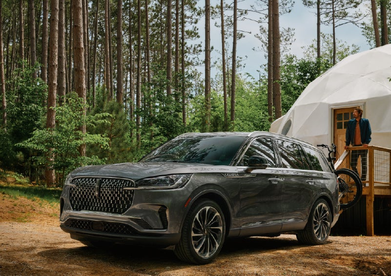 A 2027 Lincoln Aviator® is parked next to a high end glamping site. | Greenwood Lincoln in Bowling Green KY