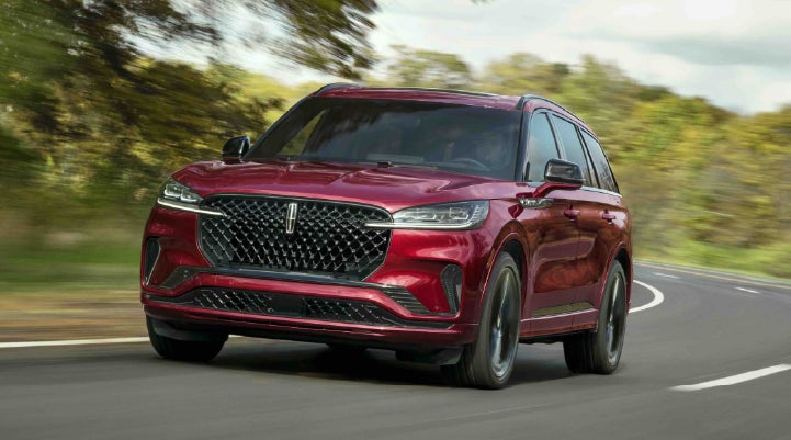 A 2027 Lincoln Aviator® SUV is being driven on a country road | Greenwood Lincoln in Bowling Green KY