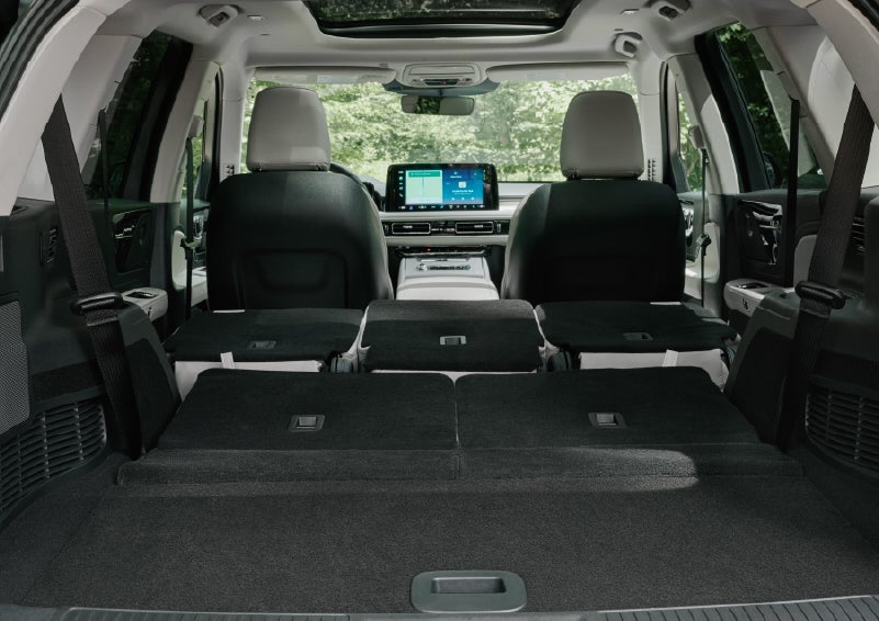 A rear to front view of the interior of a 2027 Lincoln Aviator® Black Label™ SUV shows the third and second rows folded flat | Greenwood Lincoln in Bowling Green KY