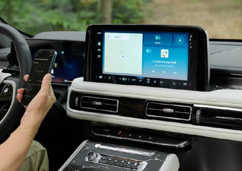 A person pairs thier phone with the center touchscreen of a 2027 Lincoln Aviator® Black Label™ SUV | Greenwood Lincoln in Bowling Green KY